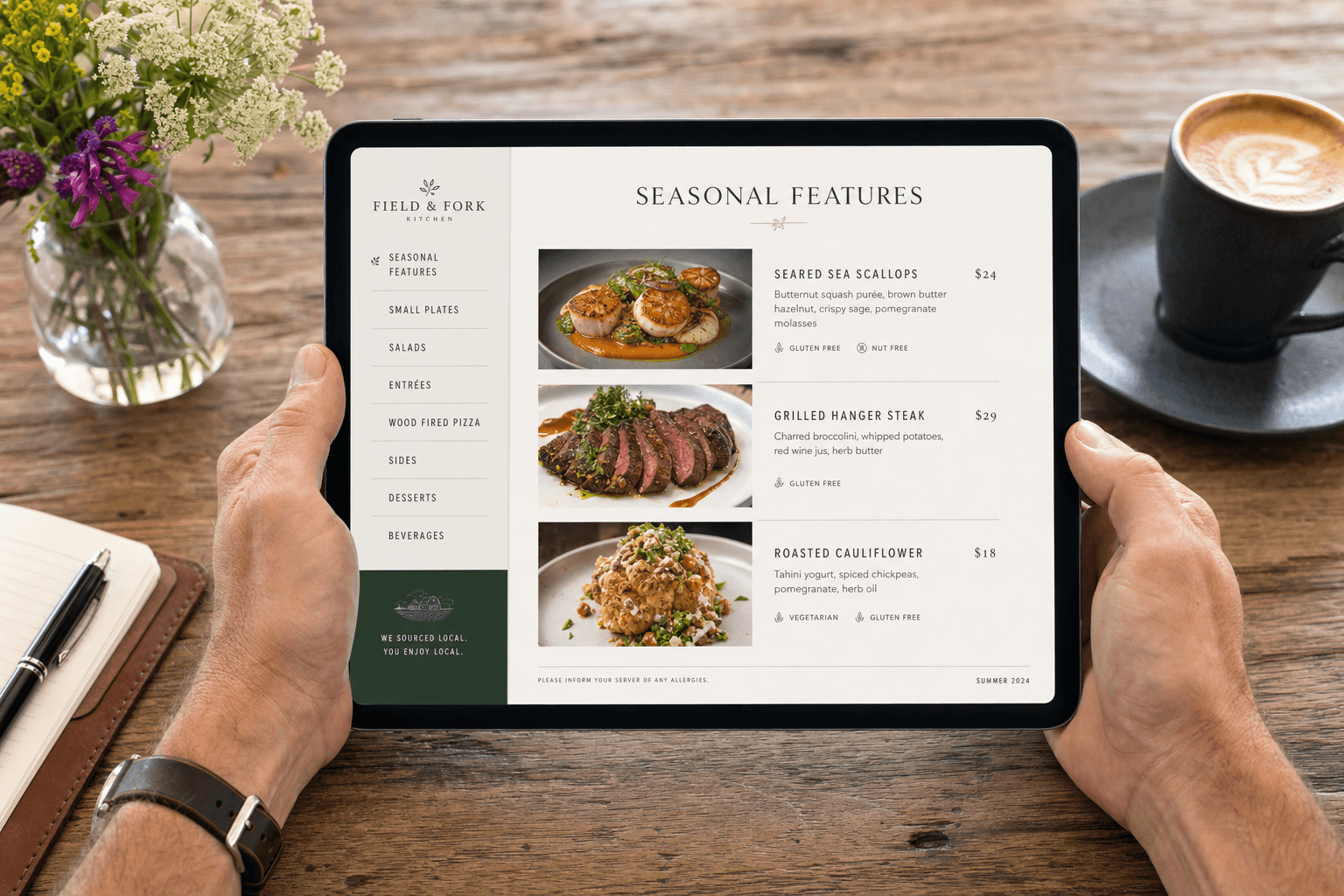 A restaurant owner reviewing a well-organized menu layout on a tablet at a wooden table